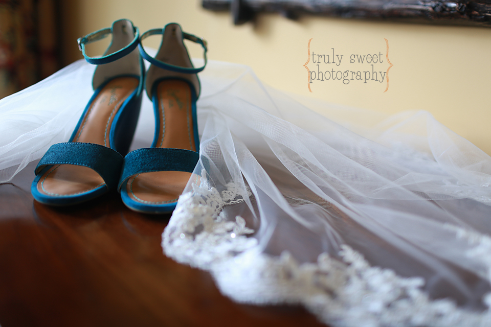 Brides blue wedding shoes with scalloped lace veil