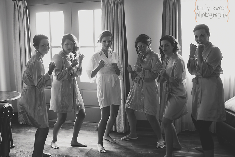 bride and bridesmaids in matching robes boxing silly